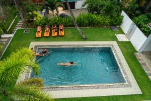 a couple of people swimming in a swimming pool at Green Hill Mirissa in Mirissa