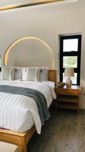 Un dormitorio con una cama grande y una ventana. en Llazara Villas, en san juan la union