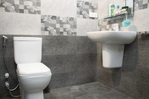 a bathroom with a white toilet and a sink at Villa Dream Nest in Unawatuna +16 photos