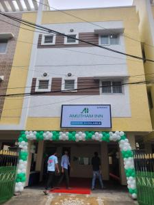 a group of people standing in front of a building at Amutham Inn in Chennai