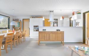 a kitchen and dining room with a table and chairs at Lovely Home In Samsø With Wifi in Nordby