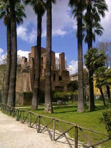 ローマにあるSacra Domus apartmentの椰子の木と柵のある建物