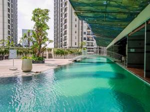 a swimming pool in the middle of a building at Good Deal and Homey Studio Pacific Garden Apartment By Travelio in Tangerang