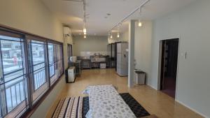 a large room with a large window and a kitchen at See 遊 in HAKUBA 和楽 in Hakuba