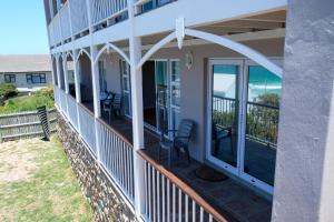 a screened porch with a view of the ocean at Bayside Cottage in Cape Town