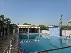 a large swimming pool on top of a building at Sagar Kuthi in Mandarmoni
