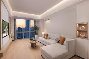 a living room with a couch and a large window at Somerset Wanxia Shenzhen in Shenzhen