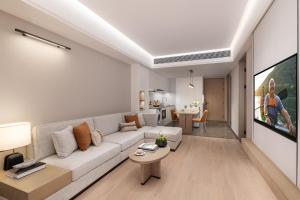 a living room with a couch and a tv at Somerset Wanxia Shenzhen in Shenzhen