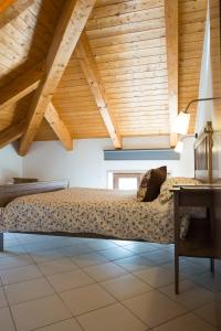 a bed in a room with a wooden ceiling at Casa Buonaiuto in Castellabate