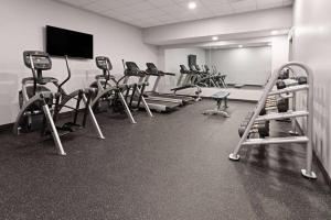a gym with a row of exercise bikes and treadmills at Hawthorn Extended Stay by Wyndham Ellsworth Bar Harbor in Ellsworth