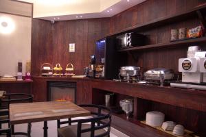 a dining room with a table and a fireplace at Daegu February Hotel DongdaeguStation in Daegu
