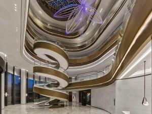 a lobby with a spiral staircase in a building at Hilton Shanghai Hongqiao International Airport in Shanghai