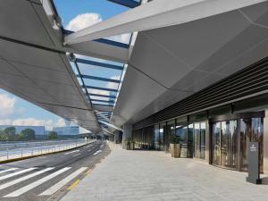a building with a walkway next to a street at Hilton Shanghai Hongqiao International Airport in Shanghai