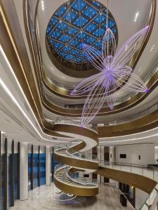 a spiral staircase in a building with a glass ceiling at Hilton Shanghai Hongqiao International Airport in Shanghai