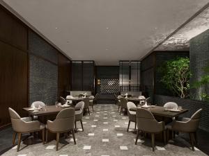 a restaurant with tables and chairs in a room at Hilton Shanghai Hongqiao International Airport in Shanghai