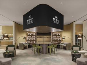 a salon with a table and chairs in a room at Hilton Shanghai Hongqiao International Airport in Shanghai