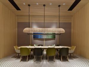 a dining room with a table and chairs under a chandelier at Hilton Shanghai Hongqiao International Airport in Shanghai