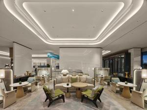 a lobby with tables and chairs in a building at Hilton Shanghai Hongqiao International Airport in Shanghai
