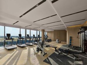 a gym with treadmills and cardio equipment in a building at Hilton Shanghai Hongqiao International Airport in Shanghai