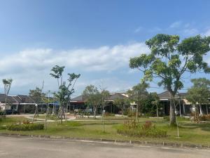 a park with a playground in front of a building at Livi Guest House in Sekupang