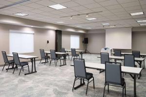 a conference room with tables and chairs and whiteboards at Wyndham Garden Otsego-Minneapolis in Otsego +49 photos