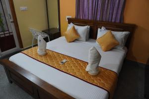a hotel room with a bed with boots on it at TIRUMALA PREMIUM HOME STAY in Tirupati