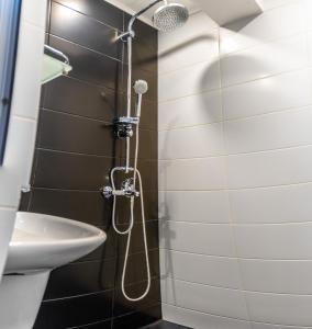 a bathroom with a shower and a sink at Guest House Malusha in Gabrovo