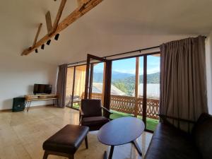 a living room with a view of a balcony at Guest house in Dilijan , whole apartment with 2 bedrooms in Dilijan