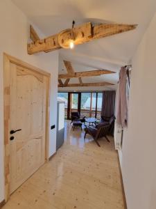 a living room with a wooden door and a table at Guest house in Dilijan , whole apartment with 2 bedrooms in Dilijan