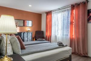 a bedroom with two beds and a window at Guest House Malusha in Gabrovo