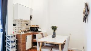 a kitchen and dining room with a table and chairs at Laticha casa in Bangsaen