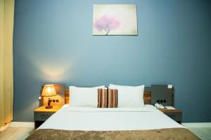 a bedroom with a large bed with a blue wall at The Saj Hotel in Ajman  +92 photos