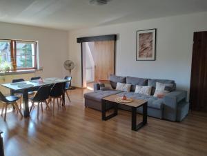 a living room with a couch and a table at Noclegi i sauna w starym domu in Pławnica +156 photos