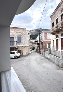 een lege straat in een stad met een berg op de achtergrond bij Urban Nest Kalymnos in Kalymnos