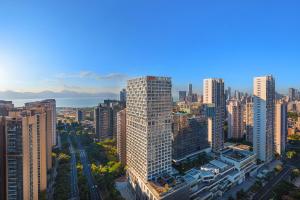 an aerial view of a city with tall buildings at Somerset Wanxia Shenzhen in Shenzhen