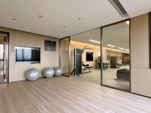 a room with a gym with a flat screen tv at Somerset Wanxia Shenzhen in Shenzhen
