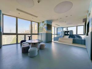 a room with a bed and a table and chairs at Somerset Wanxia Shenzhen in Shenzhen