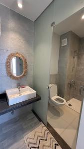 a bathroom with a sink and a toilet and a mirror at IL Monte panoramic see view chalet in Ain Sokhna +28 photos