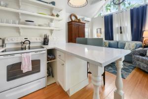 a kitchen with a white counter top and a table at Colony Poolside in Key West