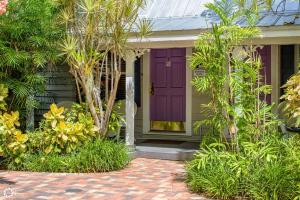 a purple front door of a house with trees at Bonaire Suite in Key West +15 photos