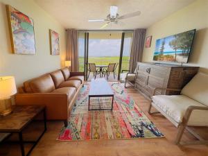 a living room with a couch and a table at Rum Cay Sunrise Suites in Key West