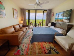 a living room with a bed and a couch at Rum Cay Sunrise Suites in Key West