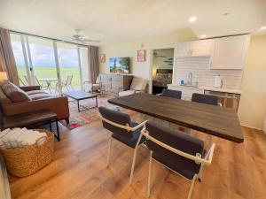 a kitchen and living room with a table and chairs at Rum Cay Sunrise Suites in Key West