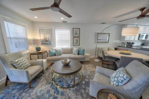 a living room with a couch and chairs and a table at Villa Serena Duval Square in Key West
