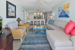 a living room with a couch and a table at Sunrise Suite 203 in Key West