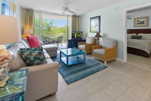 a living room with a couch and a table at Sunrise Suite 203 in Key West