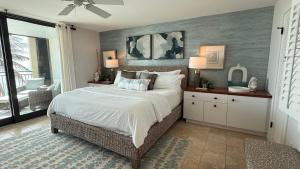 a bedroom with a bed with white sheets and pillows at Glimmer Glass Kw Beach Club in Key West +33 photos