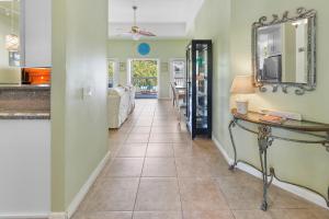 a hallway with a table and a mirror on the wall at Duval Square Courtyard Condo 31 in Key West