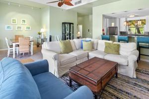 a living room with a couch and a table at Duval Square Courtyard Condo 31 in Key West +32 photos