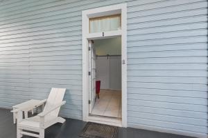 a white chair sitting on the outside of a house at La Casa De Luces in Key West